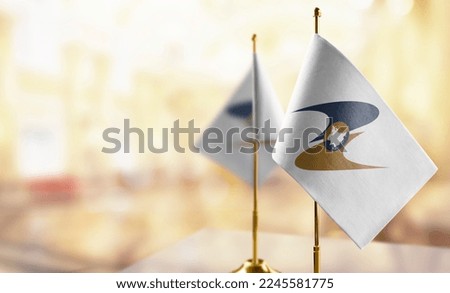 Small flags of the Eurasian Economic Union on an abstract blurry background. Royalty-Free Stock Photo #2245581775