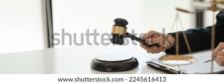 Labor law concept. Lawyer signing legal document with Judges gavel  Royalty-Free Stock Photo #2245616413