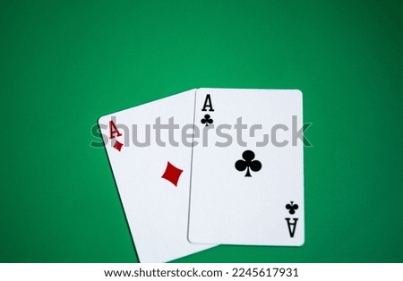 Pair of aces on green background.