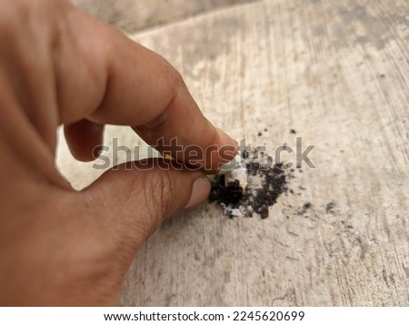 hand stubbed cigarette on the floor. high quality photos