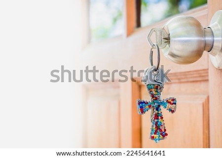 The cross key chain on door knob with sunlight, Christian concept Jesus is the key to open heaven gate, Copy space for your text