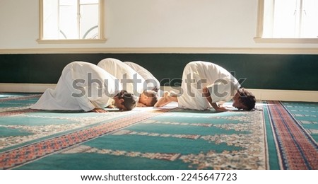 Muslim, prayer and mosque with a spiritual man group praying together during fajr, dhuhr or asr, otherwise maghrib or ishaa. Salah, worship and pray with islamic friends observing ramadan tradition Royalty-Free Stock Photo #2245647723