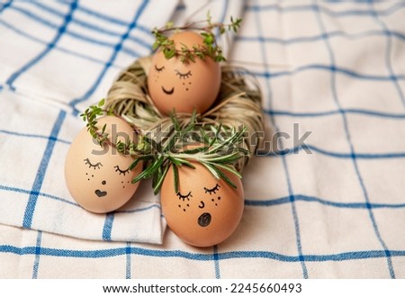 Easter egg with cute face in green plant wreath. Sleepy easter egg - Home crafts happy easter concept.