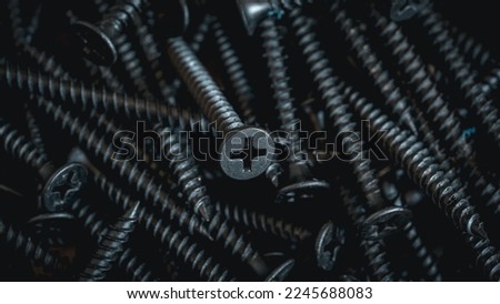 Metal screw or iron screw nails stack used in industrial building background texture.