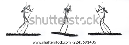 Wire puppet statue. Wire man rowing a boat. Walking wire man.
