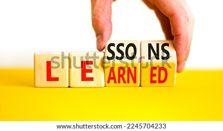 Lessons to learn symbol. Concept word Lessons learn on wooden cubes. Beautiful yellow table white background. Businessman hand. Business education and lessons to learn concept. Copy space. Royalty-Free Stock Photo #2245704233