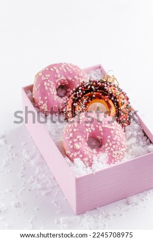 Pink tasty donuts on the box new year mood