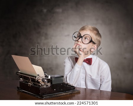 Dreaming boy with the typewriter. Retro style portrait Royalty-Free Stock Photo #224571301