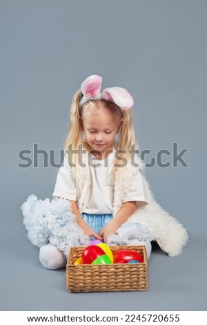 Happy easter. Girl with basket for Easter eggs and rabbit ears.