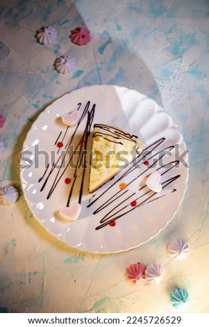 serving dessert cheesecake with marshmallows on a white plate in a cafe