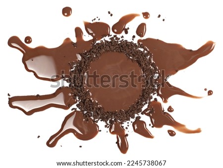 Spilled chocolate milk puddle with  chopped, milled dark chocolate isolated on white background, top view