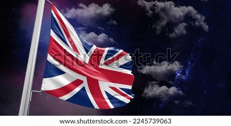 United Kingdom national flag cloth fabric waving on beautiful Blue Background.