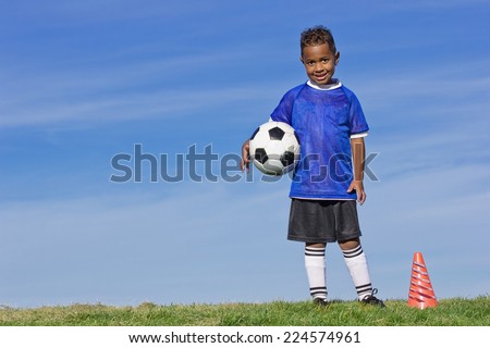 Cute Young Soccer Player holding a ball