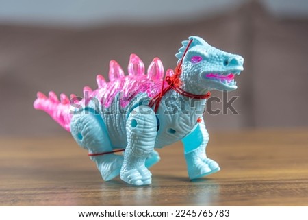 Toy dinosaurs on wooden surface. Toys. Dinosaurs Park. Miniatures and collections. Gifts for children. Adventure and fun.