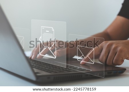 Concept email and newsletter, Business contact and communication concept. Businessman typing laptop computer to open and send email to customers on the virtual screen.