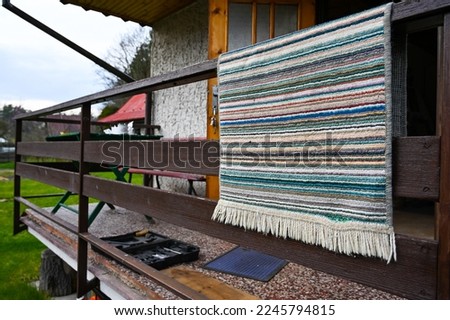 A mat thrown over the rafters at the cottage, preparation for the cottage season, winterizing the cottage Royalty-Free Stock Photo #2245794815