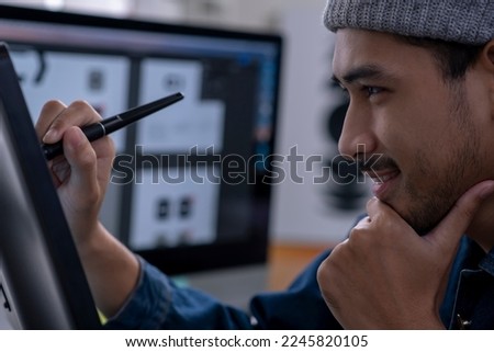 Asian male graphic designer working on computer drawing sketches logo design. The concept of a new brand. Professional creative occupation with idea.
