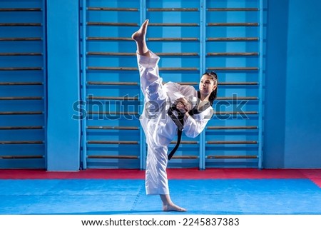 Young sport woman  practicing martial art of taekwondo, healthy lifestyle concept Royalty-Free Stock Photo #2245837383