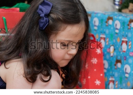 young girl opening christmas presents