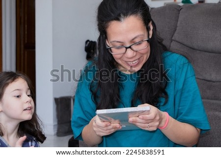 young woman opening christmas presents at home