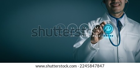 Doctor pressing smiley face emoticon on virtual touch screen. Patient and customer service evaluation concept. Digital link wellness and health tech. Hospital survey online. Royalty-Free Stock Photo #2245847847