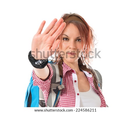 backpacker making stop sign over white background