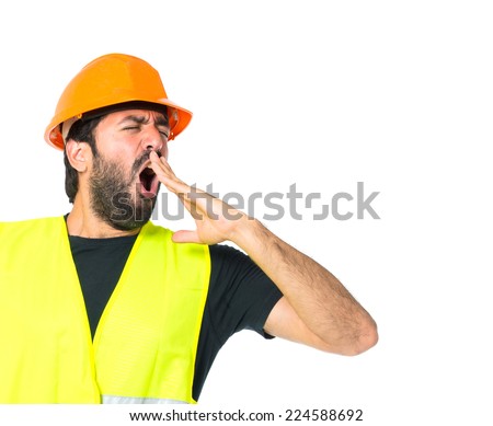 Workman yawning over isolated white background