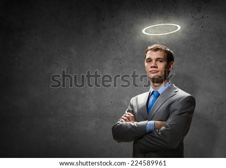 Young handsome businessman with halo above head