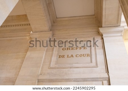 greffe de la cour text on ancient wall facade building means in french justice court clerk of the court courtroom Royalty-Free Stock Photo #2245902295