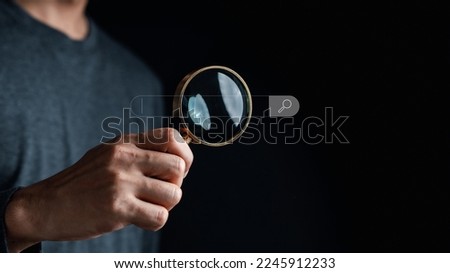Businessman use magnifying glass Search On Virtual Screen Data Search Technology Search Engine Optimization. Man use computer to Searching for information. Using Search Console for data.