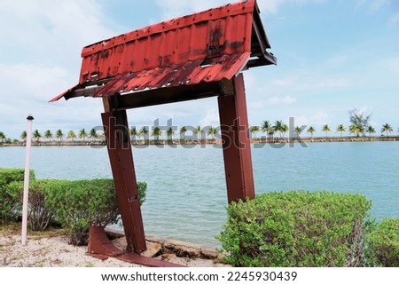 an old gate in a park to take pictures facing the sea with a background of lined coconut tree