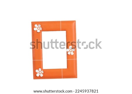 Orange leather frame on a light wooden background. Isolate on white.