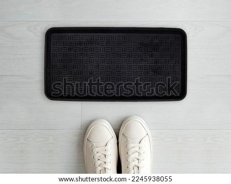 Designer Welcome Entry Doormat Placed on White Floor with White Shoes