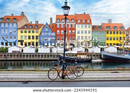 The popular Nyhavn area at Copenhagen, Denmark, with a street light and bicycles in front of the colorful houses Royalty-Free Stock Photo #2245944191