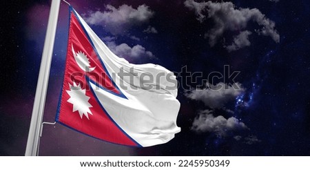 Nepal national flag cloth fabric waving on beautiful Blue Background.
