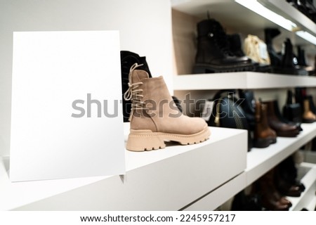 perspective view of point of sale empty shelf sign poster holder mockup in retail shoe store window