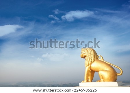 Yellow lion statue isolated on blue sky background at Dhauli Shanti Stupa in Bhubaneswar, Odisha, India. Dhauli or Dhauligiri Buddhist shrine built by King Ashok after the war of kalinga Royalty-Free Stock Photo #2245985225