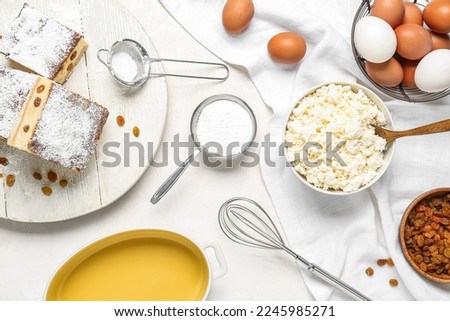 Ingredients for preparing cheese pie on white background
