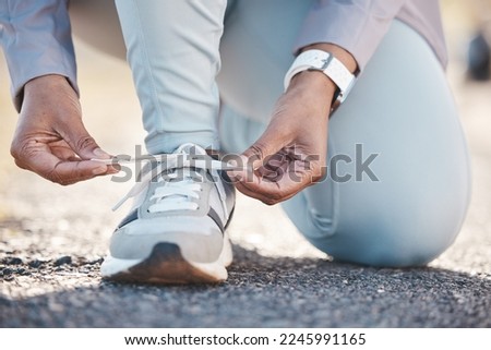 Woman, hands and shoelace for street runner, outdoor workout and fitness in summer sunshine in morning. Running adventure, shoes and tie lace for safety, speed and balance in road exercise for health Royalty-Free Stock Photo #2245991165