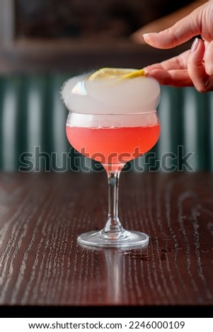 Cosmopolitan cocktail. Cosmo cocktail, is a cocktail made with vodka, Cointreau, cranberry juice, and freshly squeezed or sweetened lime juice. Classic drink made famous on popular TV shows. 