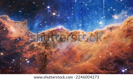 Cosmic Cliffs in the Carina Nebula. James Webb Space Telescope. Glittering Landscape of Star Birth. Elements of this image furnished by NASA. Royalty-Free Stock Photo #2246004273