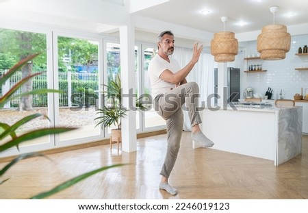 Senior caucasian man doing exercise tai chi gym at home. Chinese management skill energy. Mature old man play tai chi. Healthcare meditation yoga skill. Activity hobby leisure time for retire people. Royalty-Free Stock Photo #2246019123