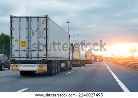 Lorry trucks cars in traffic jam at border zone custom, sunset time Royalty-Free Stock Photo #2246027495