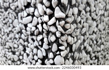 White decorative gravel background. Garden pond gravel background. Seamless texture of white stone or gravel. Adhesive decoration on the wall or floor. Enhanced protection. (selective focus)