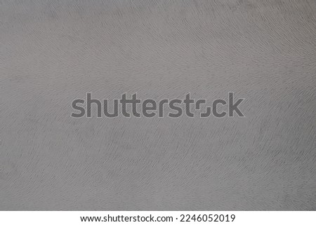 Texture of grey fabric, imitation of animal fur. Abstract grey background. Photo.