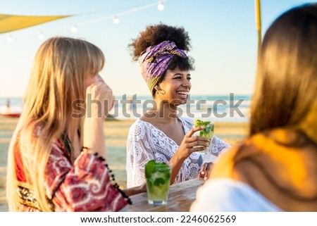 African girl having fun drinking mojito at bar on the beach - Friendship, leisure and travel concept