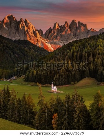 Val Di Funes, Dolomites, Italy - The beautiful St. Johann Church at South Tyrol with the Italian Dolomites and spectacular colorful sunset at background on a warm autumn afternoon Royalty-Free Stock Photo #2246073679