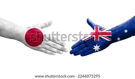 Handshake between Australia and Japan flags painted on hands, isolated transparent image.