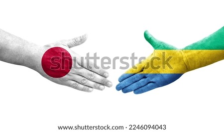 Handshake between Gabon and Japan flags painted on hands, isolated transparent image.