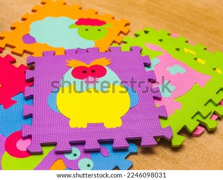 Children's multi-colored Puzzle made of foamed polyethylene close-up on a carpet background